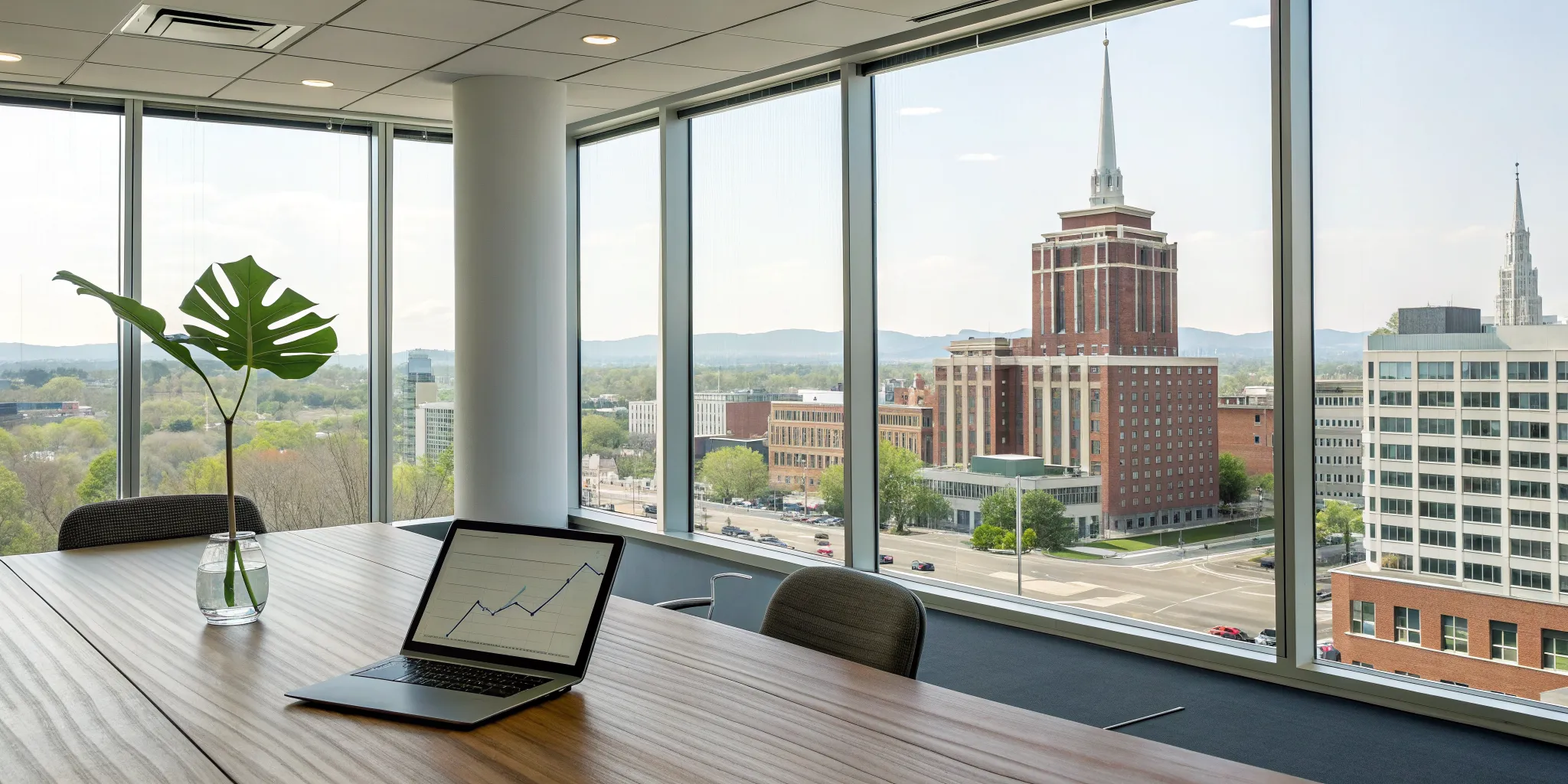 Calculating the total cost of ownership for an HVAC system in Lexington on a laptop with a cost graph.