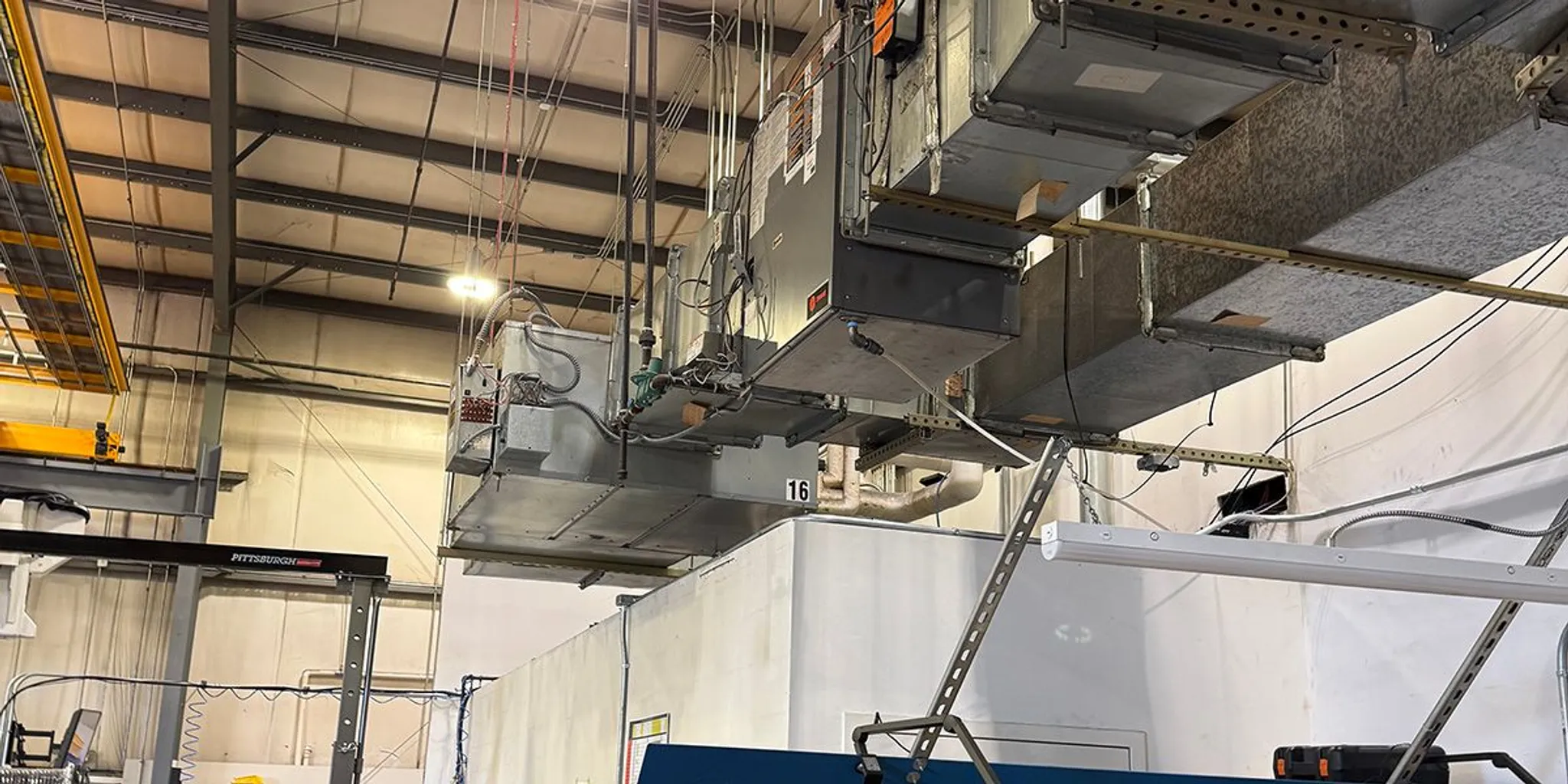 Industrial air-handling equipment and ductwork serving a manufacturing plant